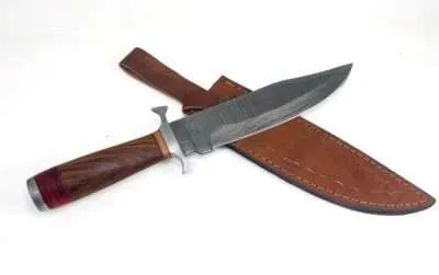 Walnut wood handle with maple and laminated wood accents and Damascus blade. Brass guard and endcap.
